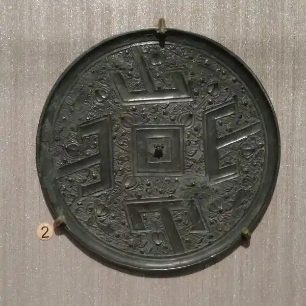 Bronze mirror with four-point cross-like design, National Palace Museum